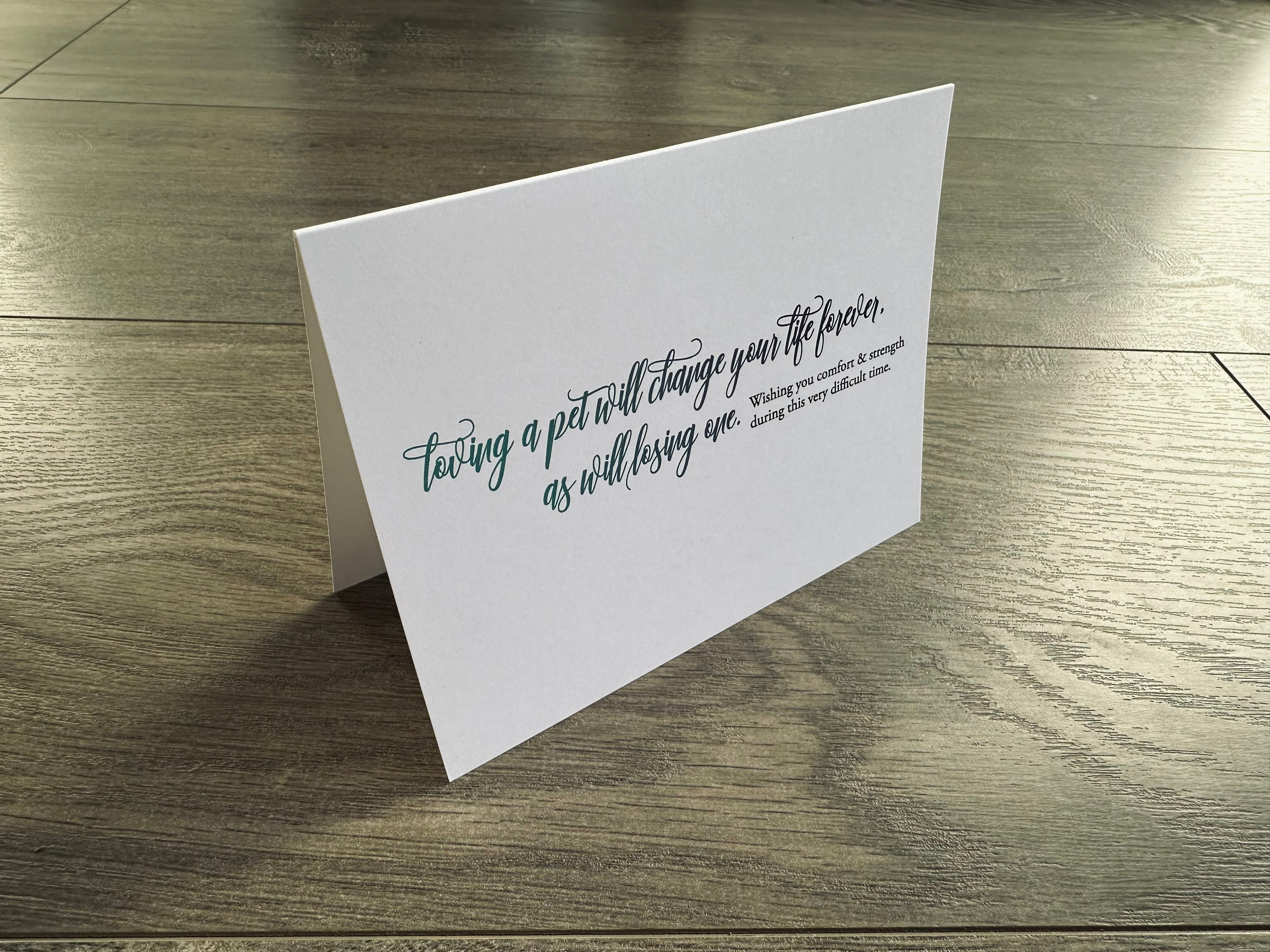 A white folded notecard says "loving a pet will change your life forever, as will losing one. Wishing you comfort and strength during this very difficult time." Loss of Pet collection by Stationare.