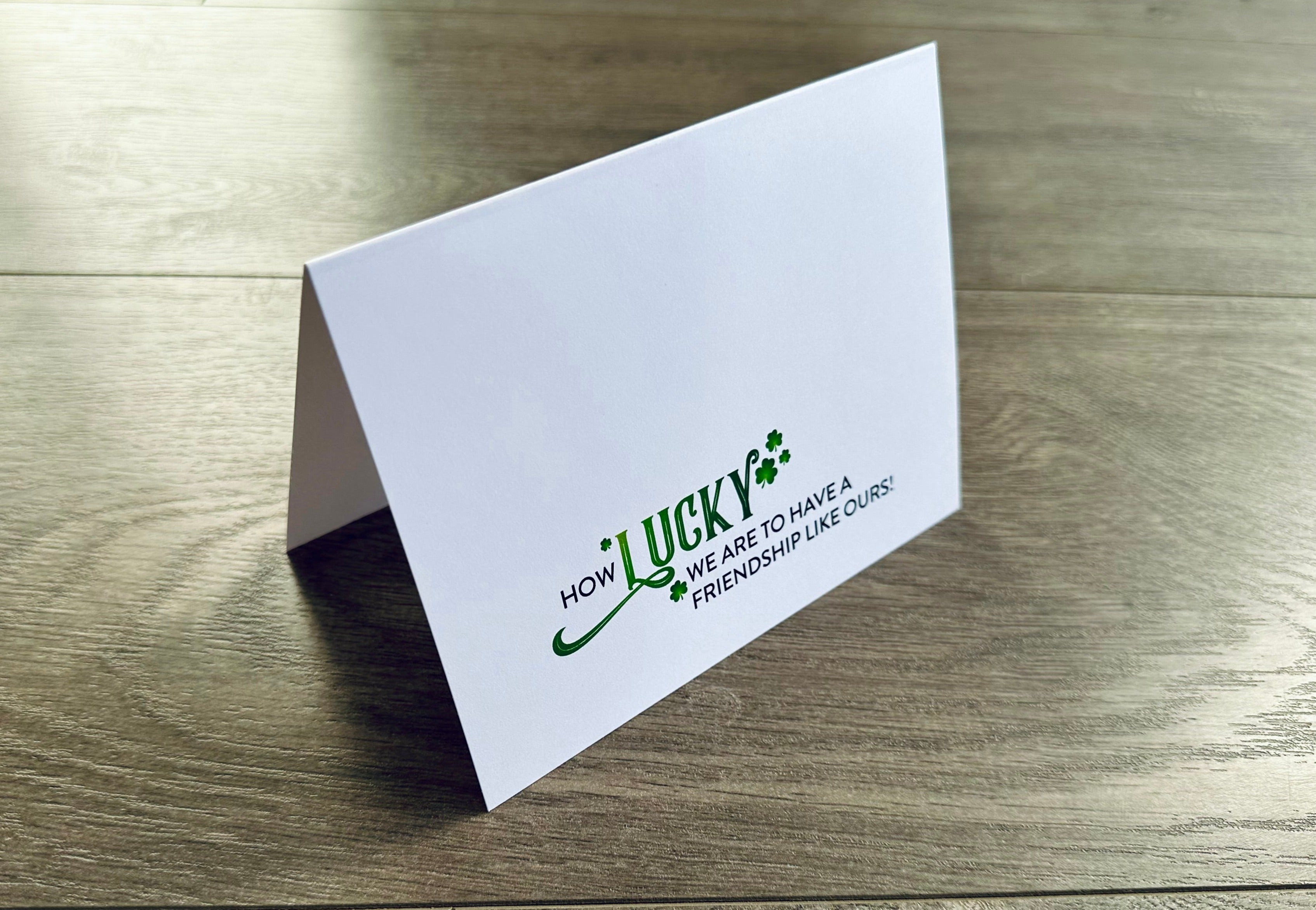 A white folded notecard reads, "How lucky we are to have a friendship like ours!" Friendship Luck by Stationare.