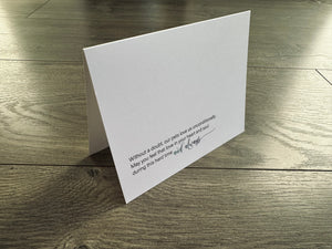 A white folded white notecard  stands on a wooden floor. It reads, "Without a doubt, our pets love us unconditionally. May you feel that love in your heart and soul during this hard time and always." Loss of Pet Collection by Stationare.