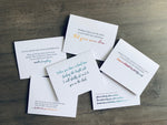 The six white notecards from Stationare's Sending Support collection lie on a wooden background. Each card has an uplifting sentiment to encourage someone through a challenging time.