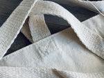 closeup of secure handles of the natural canvas tote by stationare