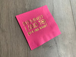 pink cocktail napkin on a wooden background. Metallic gold foil printing that reads Be Mine? I said to give me wine! Valentines's Day napkin by Stationare for girls night party, galentines, or a valentine party