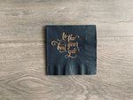 Black cocktail napkin lying on a wooden background. In metallic gold foil, a script font reads, "to the best year yet." perfect for New Years Eve or a birthday!