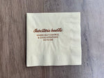 Ivory colored napkin on a gray/brown wooden backdrop. In metallic rose gold foil, the text reads: Charcuterie Boards - where self-control and good intentions go to die. By Stationare.