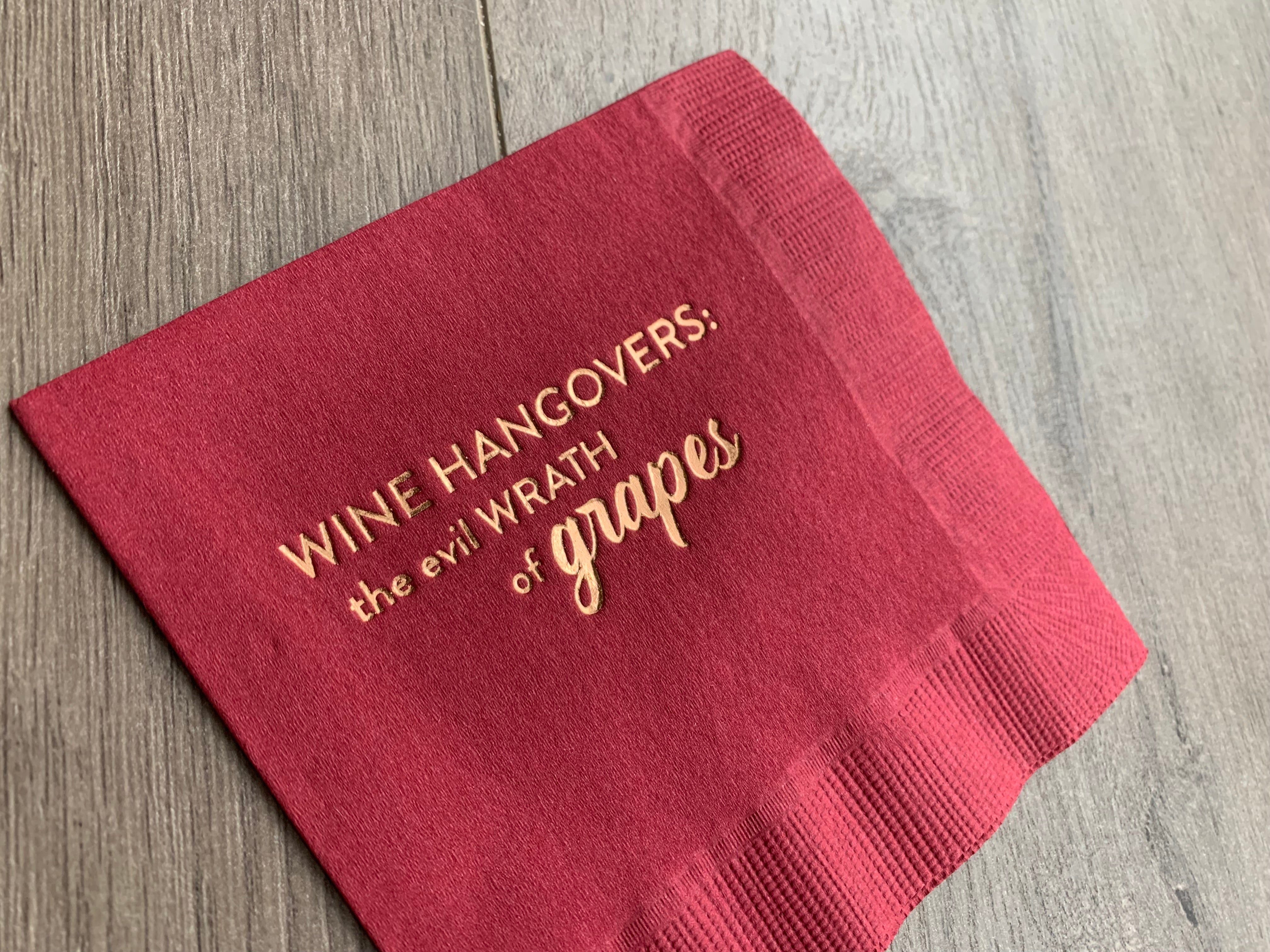 closeup of gold foil on Wine Hangovers: the evil wrath of grapes cocktail napkin by Stationare
