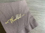 closeup of brown thankful cocktail napkin by stationare