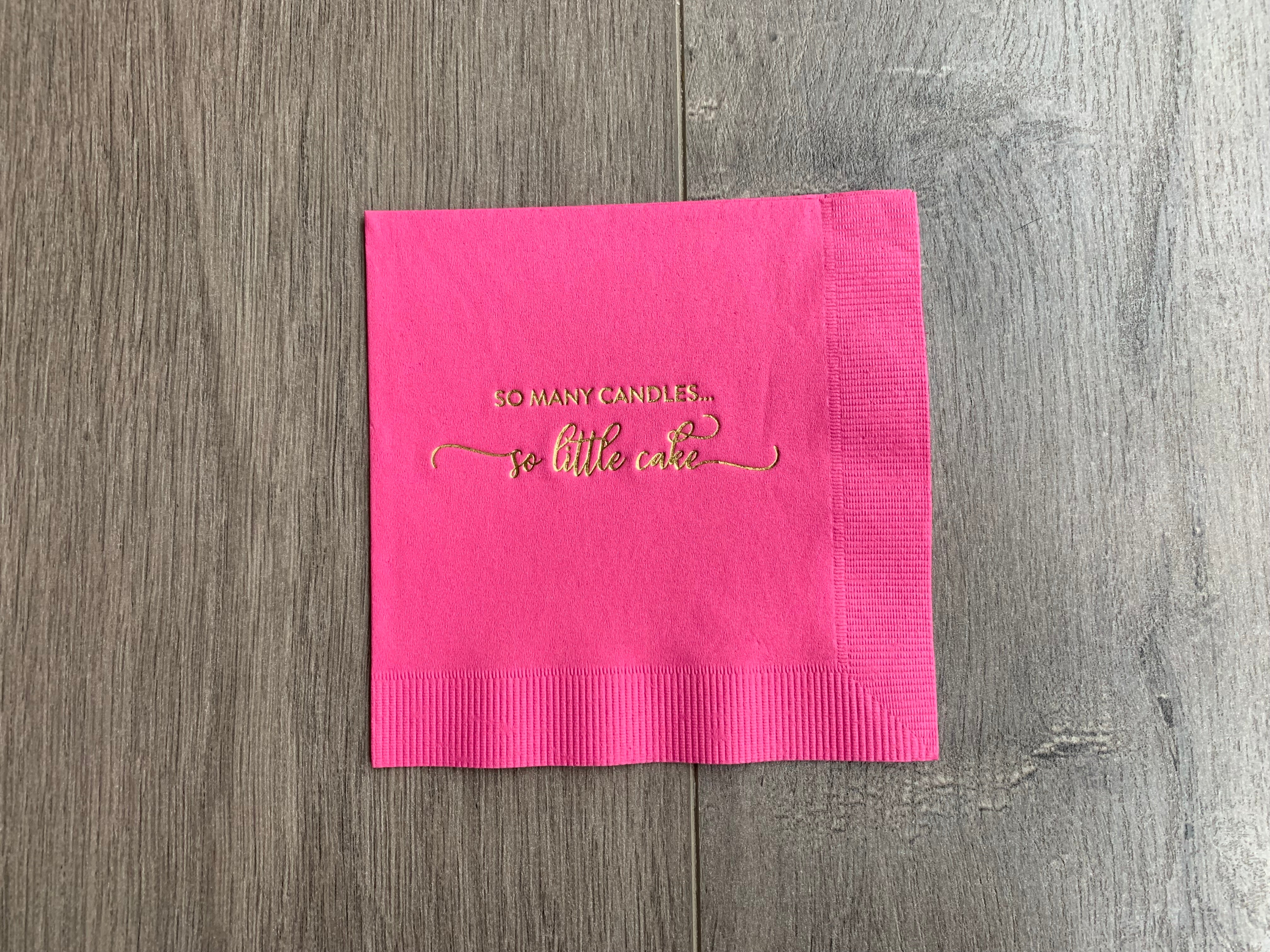 Stationare's bright pink birthday cocktail napkin with gold foil printing that reads "so many candles, so little cake"
